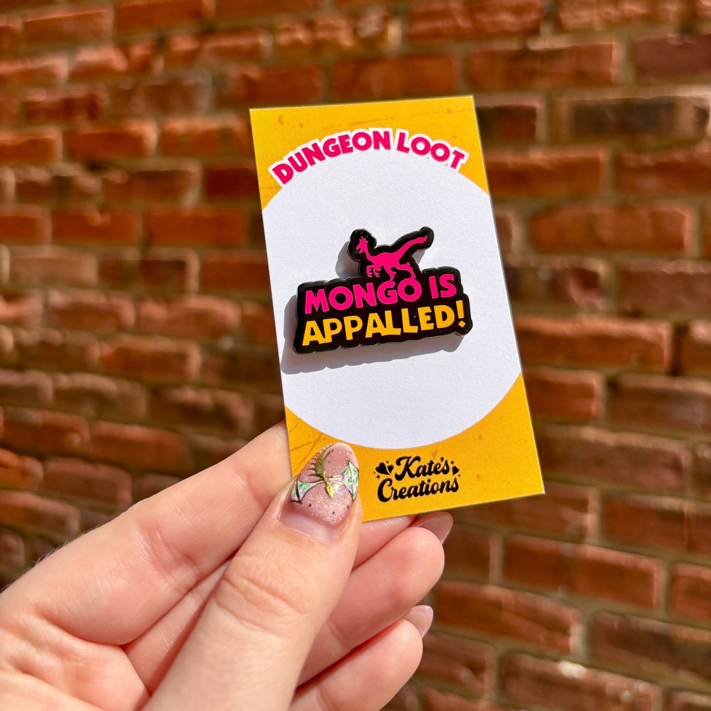 Hand holding a small card with 'Dungeon Loot' branding against a brick wall background